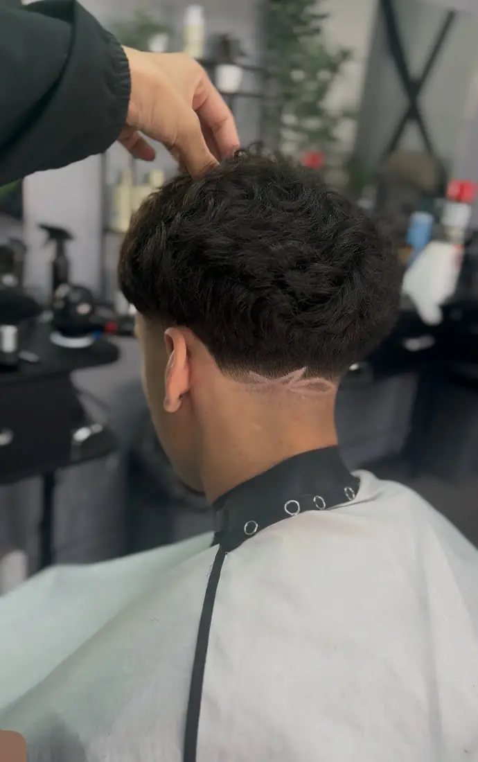 Taper with a hair design at the back